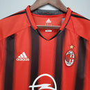 Camiseta retro AC Milan Away 04/05, design listrado vermelho e preto, logotipo adidas e símbolo do AC Milan