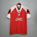 Camisa retro Arsenal Home 92/93, modelo Adidas, na cor vermelha com detalhes em branco e listras pretas.
