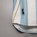 Camisola Argentina Home 06/07 Retro, detalhe da parte inferior com padrão listrado azul e branco.