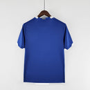 Camisola Brasil Away 2006 Retro vista traseira em azul com detalhes em branco, destacando um visual clássico e elegante.