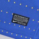 Camisola Brasil Away 2010 Retro com etiqueta de autenticidade e design azul com poás amarelos.