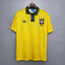 Camisola Brasil Home 91/93 Retro na cor amarela, com logo e detalhes em verde e azul.
