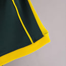 Camisola Brasil Home 98/99 Retro com detalhes em amarelo e verde.