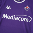 Camisola principal da Fiorentina 2025/26 Kappa, em violeta com detalhes brancos, com escudo do clube e logótipos Kappa nas mangas e peito.