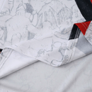 Camisola branca do Manchester City 25/26 com faixa diagonal preta e vermelha, padrão Poznań e detalhes artísticos da colaboração KidSuper x Puma