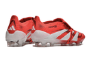 Chuteira Adidas 25 Predator Elite Tongue FG em vermelho e branco, ideal para desempenho em campo.
