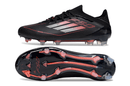 Chuteira Adidas F50 Elite FG - Preta e Vermelha: vista lateral e solado em tecnologia FG para desempenho em campo.