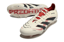 Chuteira Adidas Predator Elite FG - Bege, Preta e Vermelha em destaque com design sofisticado e detalhes tecnológicos.