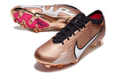 Chuteira Nike Air Zoom Mercurial Vapor 15 Elite FG em cor bronze com detalhes em preto e branco.