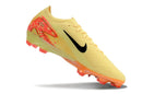 Chuteira Nike Mercurial Air Zoom Vapor 16 Elite FG Amarelo e Laranja em ângulo, destacando cores vibrantes.