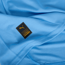 Camisa Manchester City home 24/25 azul com logo da Puma e selo de autenticidade.