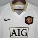 Camisa retro do Manchester United Away 06/07 com detalhes em dourado e logotipo do time.
