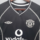 Camisa retrô Manchester United 00/02, detalhes em preto e branco, marca Umbro.