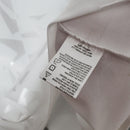 Etiqueta de cuidado do produto Manchester United Home 1991 Retro, mostrando instruções de lavagem e material.