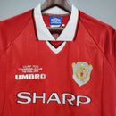 Camisa retrô Manchester United Home 99/00, destacando o escudo e detalhes da marca Umbro.
