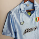 Camisolas Napoli Home 90/91 Retro, camiseta de futebol azul com logo Mars e detalhes em verde e vermelho.