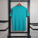 Camisola Real Madrid Third 17/18 Azul vista traseira em fundo preto e prateado.